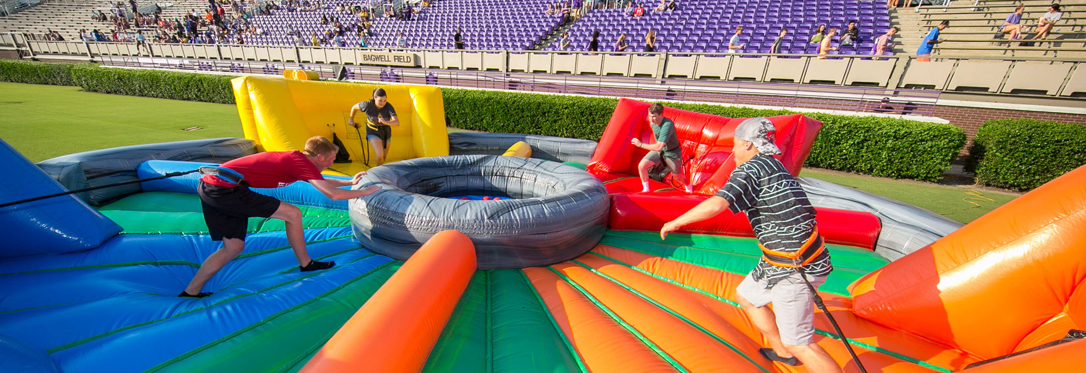 Students setting up an inflatable ride